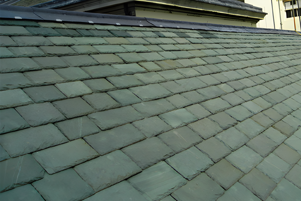 Slate roof with overlapping rectangular tiles in geometric pattern, weathered finish