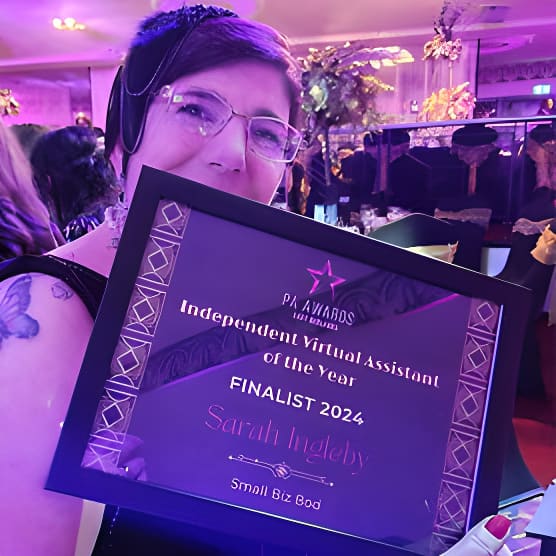 Person holding Independent Virtual Assistant of the Year Finalist 2024 award at event
