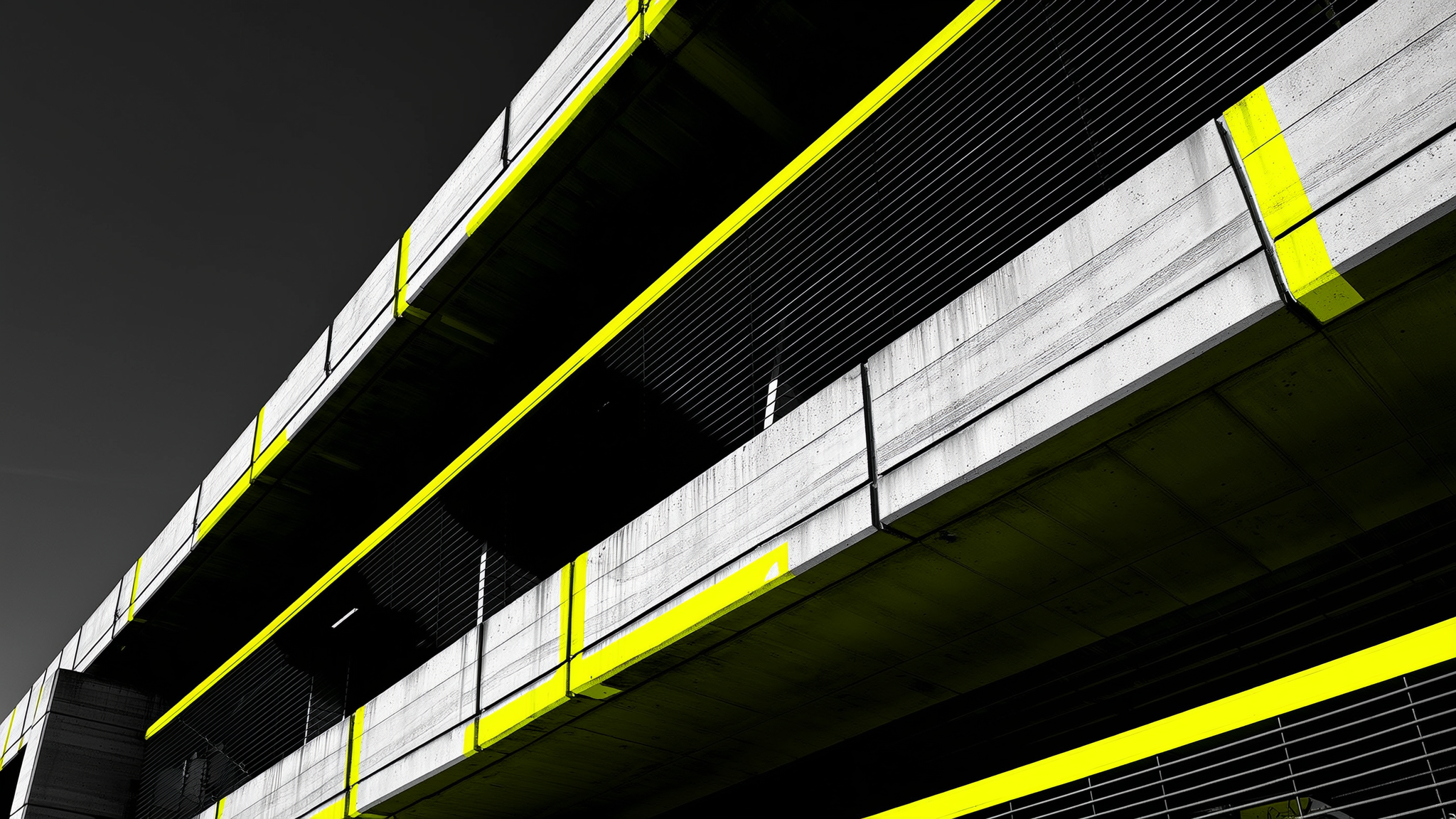 Modern concrete parking structure with bright yellow safety railings and trim
