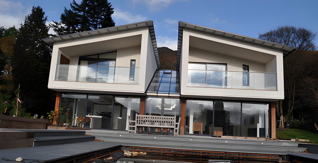 Contemporary house with white render, timber posts, large windows, and deck